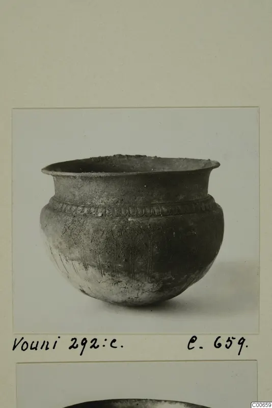 Dark grey vessel with a flaring rim and a band of impressed pattern below the rim, from Vouni