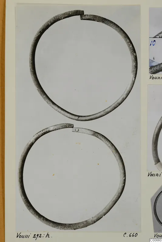 Two open metal bracelets from Vouni, photographed on a mounted card with other photographs at the right edge