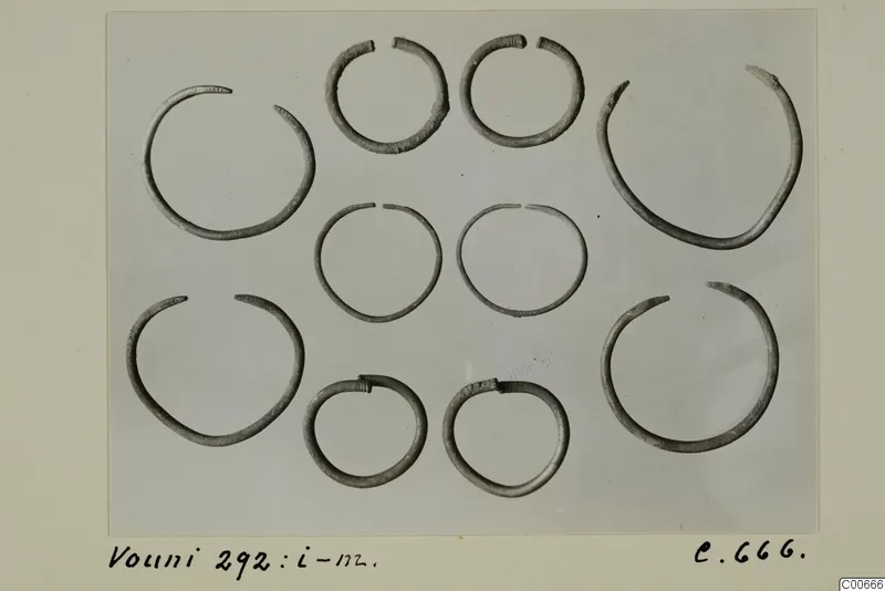 Silver hoop bracelets from Vouni 292 laid out in rows on a pale grey background