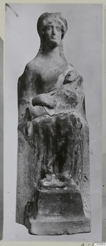 Terracotta figurine of a seated adult holding a child in the lap