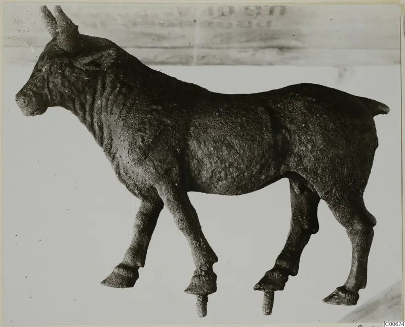 Bronze statuette of a standing horned animal from Vouni, shown in side view