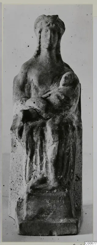 Terracotta figurine of an adult holding a child in their arms, shown frontally against a plain background