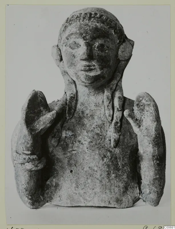 Small bust of a figure with braided hair and raised hands, from Vouni