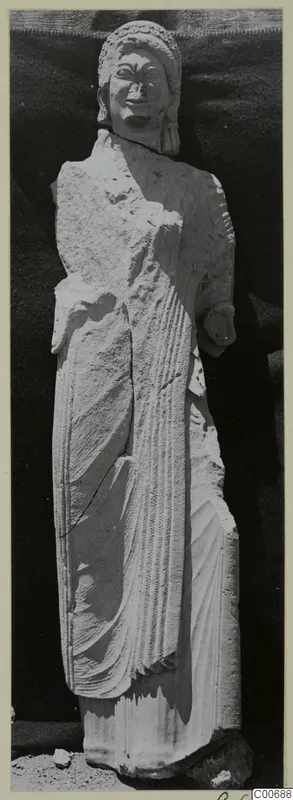 Standing limestone statue of a woman from Vouni, shown against a dark backdrop
