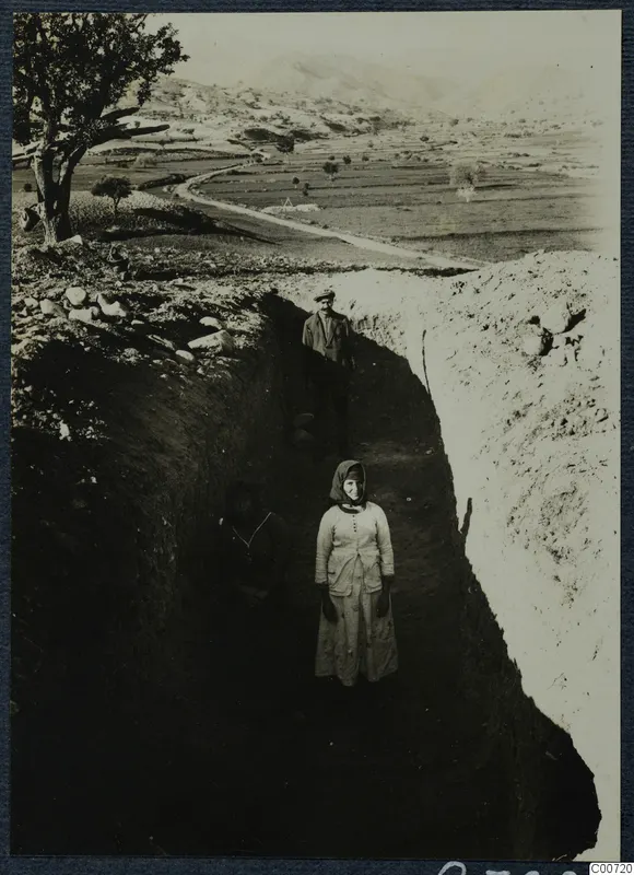 Test trench 2 at Pezoullia, Soli, with two women and a man standing in the trench.