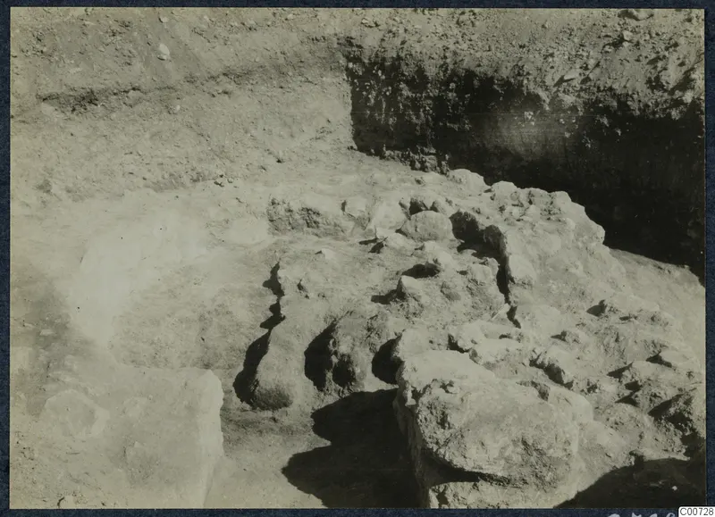 Excavation at Vouni Palace showing exposed stones and rubble in a trench