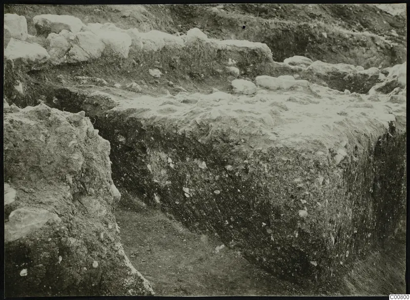 Excavation trench at Plakes, Lapithos, with rows of stones exposed in the soil face