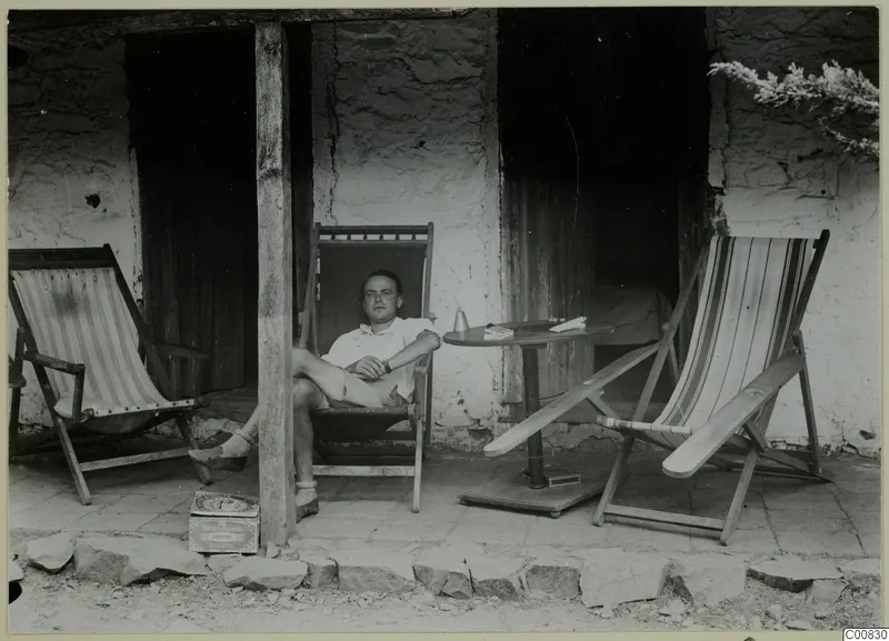Erik Sjöqvist seated in a deck chair on a stone-paved veranda at Machairas