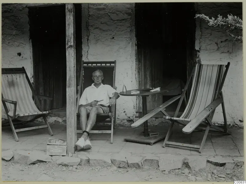 John Lindros seated in a deck chair on a veranda at Machairas.
