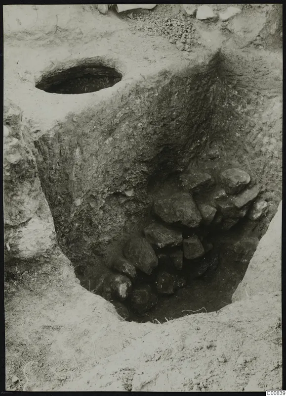 Excavation at Plakes, Lapithos, with a heap of stones filling the lower part of a cut trench.