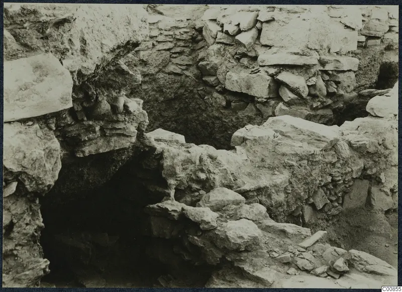 Excavated stone walls and fallen stone blocks at the Idalion acropolis during excavation