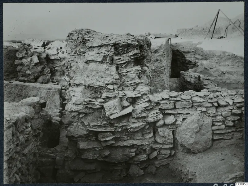 Excavated stone walls at Idalion Acropolis, with a timber frame at the upper right