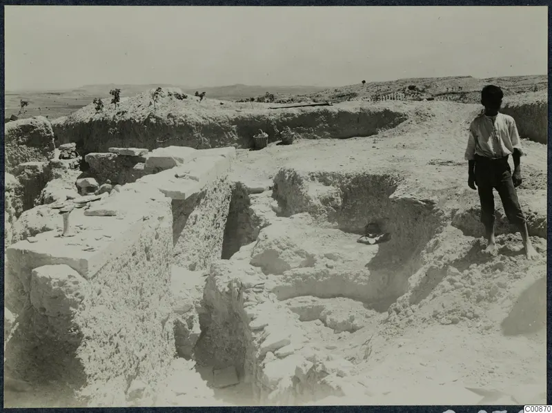 Excavation at the Acropolis of Idalion, with a young boy standing on the spoil beside the trenches