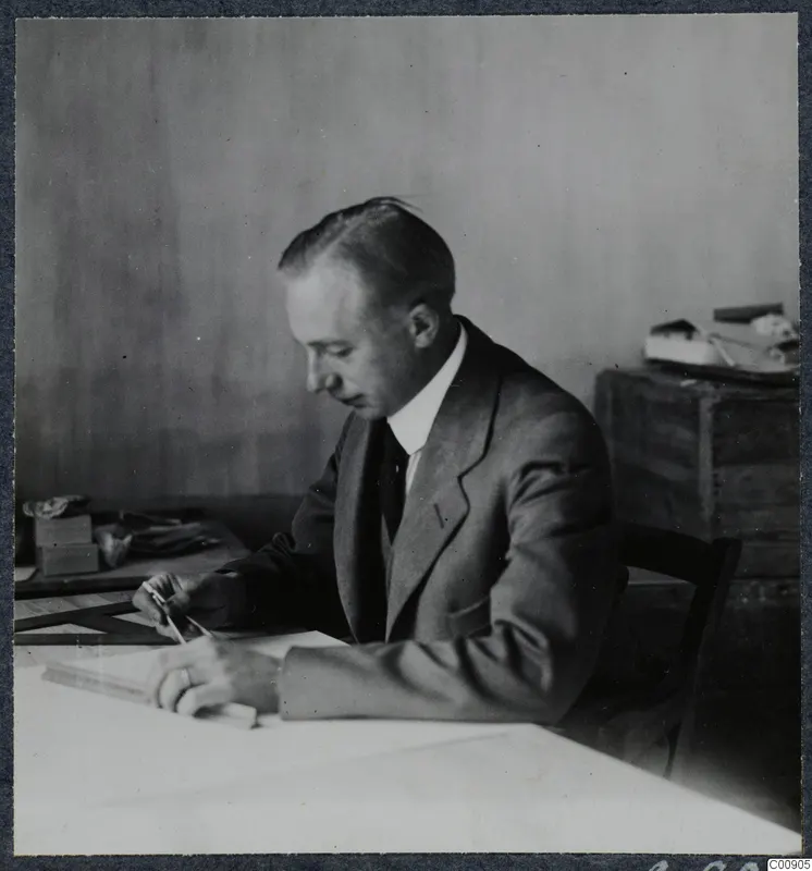 John Lindros seated at a drawing board in Nicosia, working with a pencil and drawing instruments