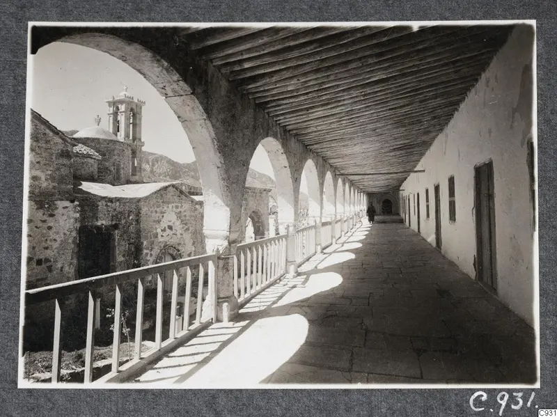 Arcaded covered gallery with a timber roof and a domed church with bell tower, at the monastery at Lambousa