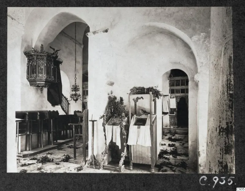 Interior of the monastery church, Lambousa, with a carved wooden pulpit and dark wooden benches