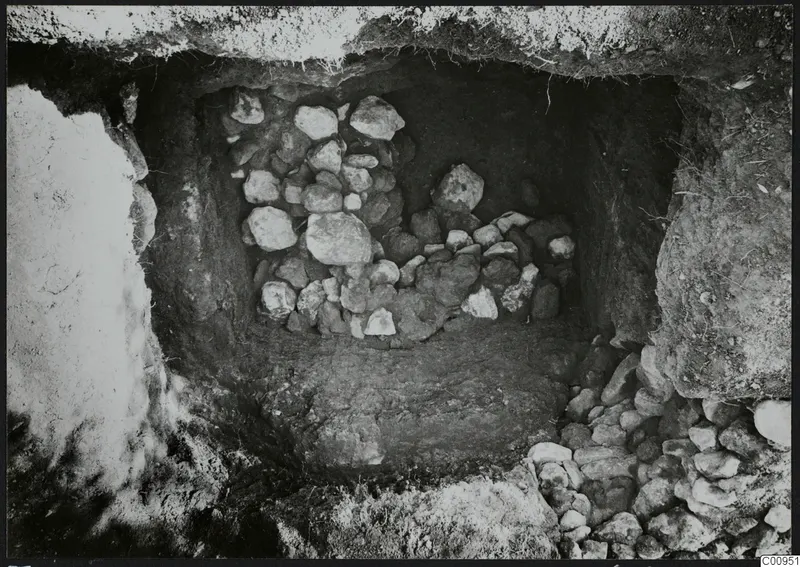 Tomb 429 at Lapithos: burial chamber with a heap of stones during excavation