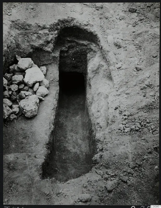 Tomb 426 at Lapithos Kastros: entrance to a tomb chamber through a sloping passage, with a pile of stones beside it