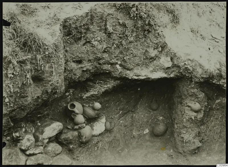 Pottery vessels in situ in an excavated tomb cavity at Kylistra, Lapithos