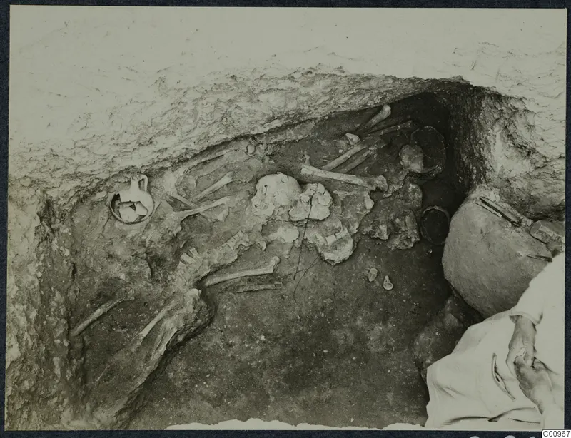 Excavation at Idalion with a skeleton and a small handled vessel in a pit