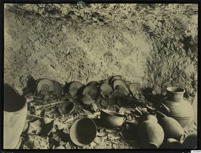 Tomb 428 at Lapithos Kastros: broken sherds and vessels on the floor of the tomb chamber during excavation