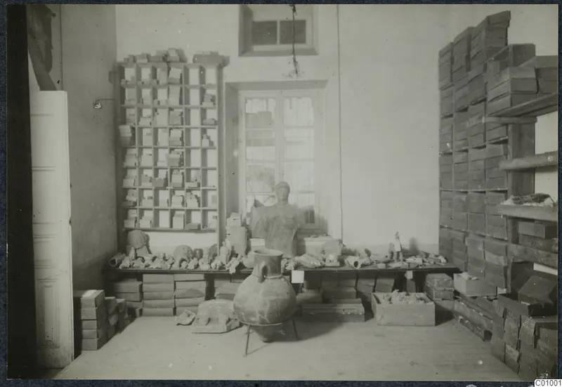 Storeroom in the Swedish Institute in Nicosia with a bust, terracotta heads and a large jar on a bench