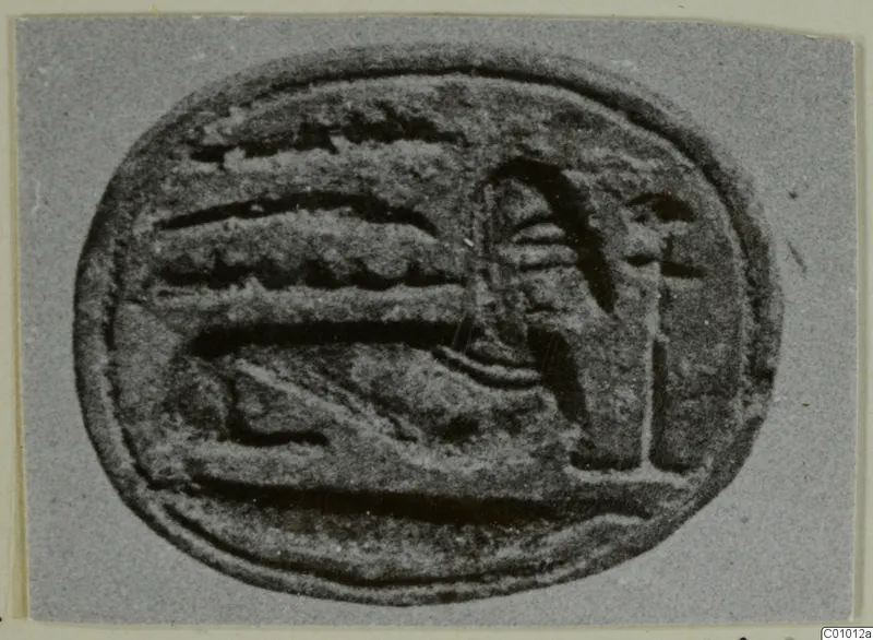 Oval engraved seal with a raised design of bands and an upright figure-like form, photographed on grey card