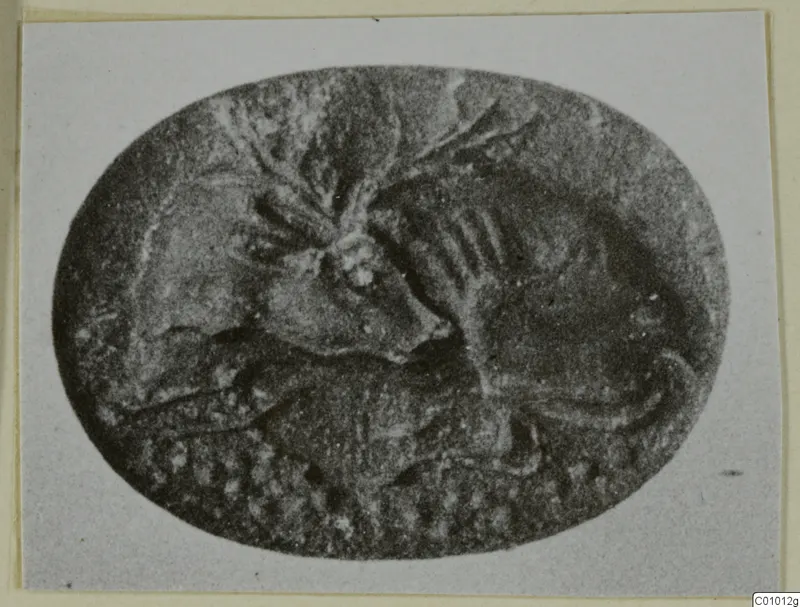 Oval engraved stone seal with a carved design of an animal figure and other motifs