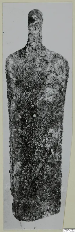 Corroded bronze scraper from the Vrysi tou Barba tombs at Lapithos, shown from the front