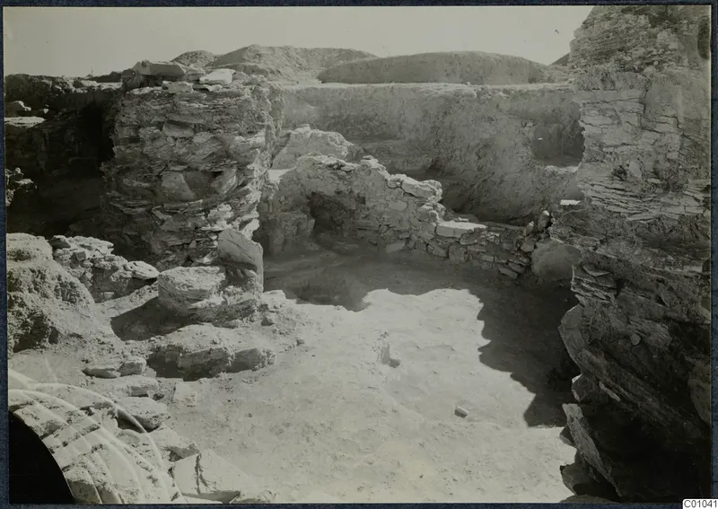 Excavated area on the Idalion acropolis with stone walls and rubble around an open floor