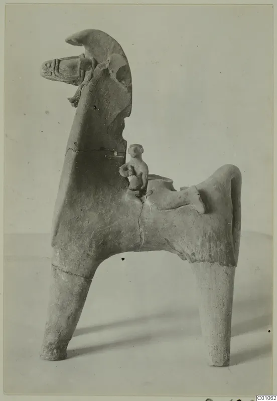 Terracotta figure of a horse with a small rider seated on its back, shown against a plain pale background.