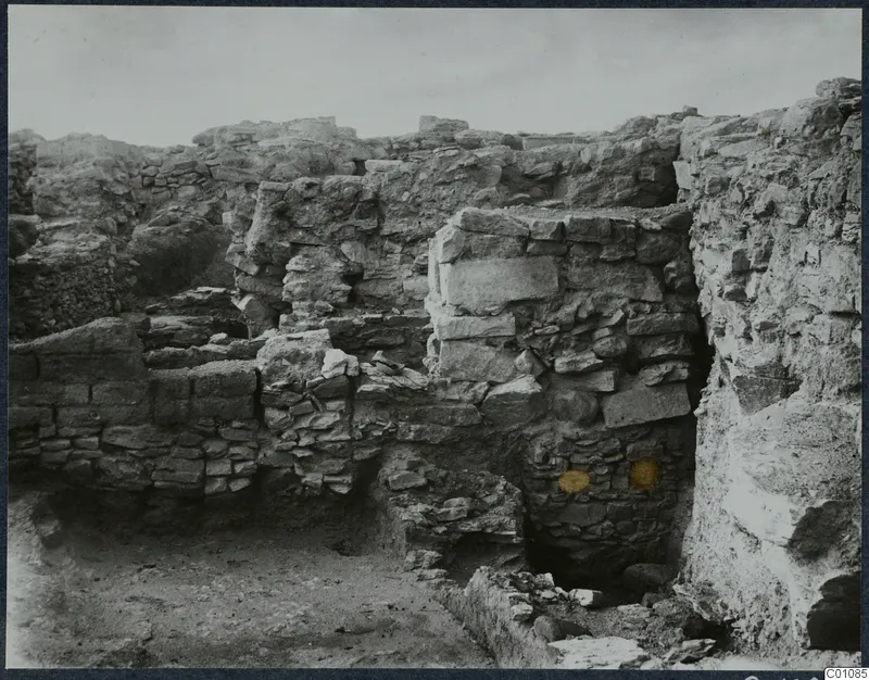 Excavated stone walls on the Acropolis at Idalion, with rubble and bare soil in the foreground