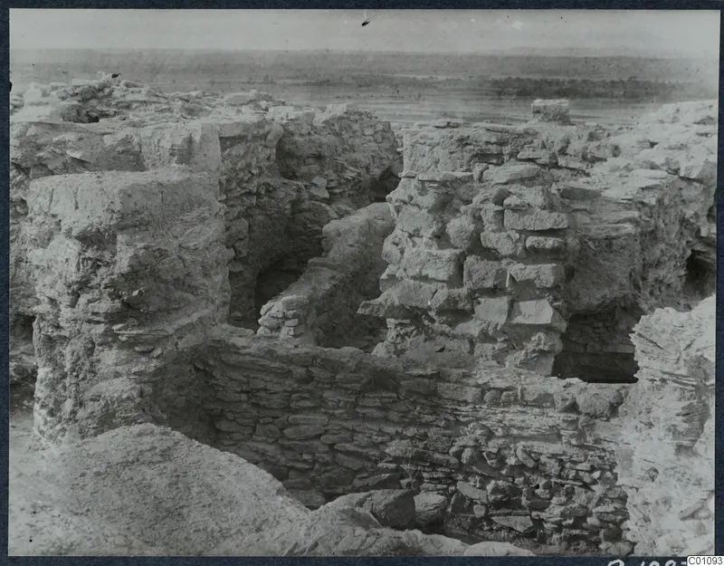 Exposed stone and earth walls of ruins on the Idalion acropolis, with a flat plain beyond.