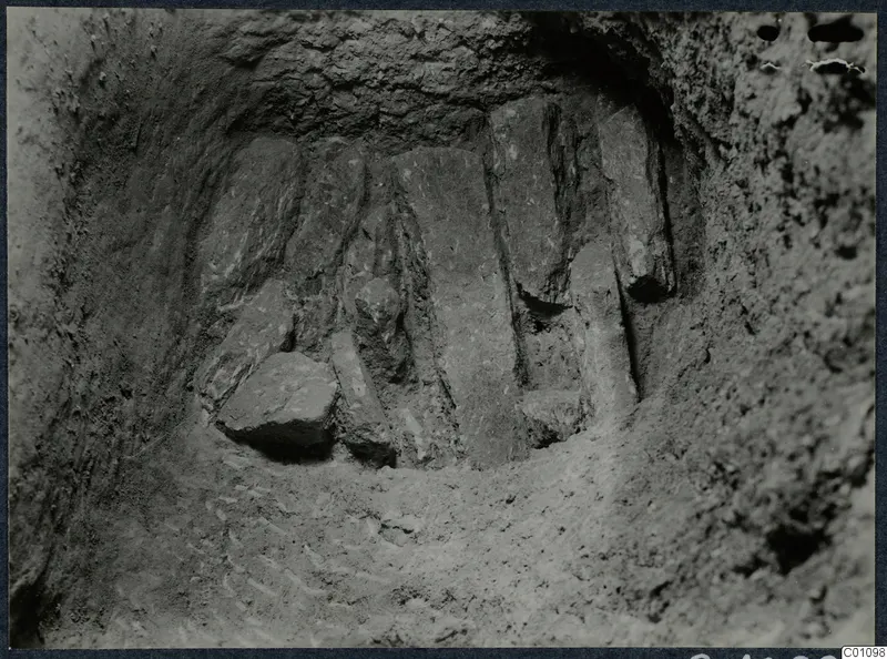 Excavated cut at Idalion with upright flat stone slabs set side by side against the back wall