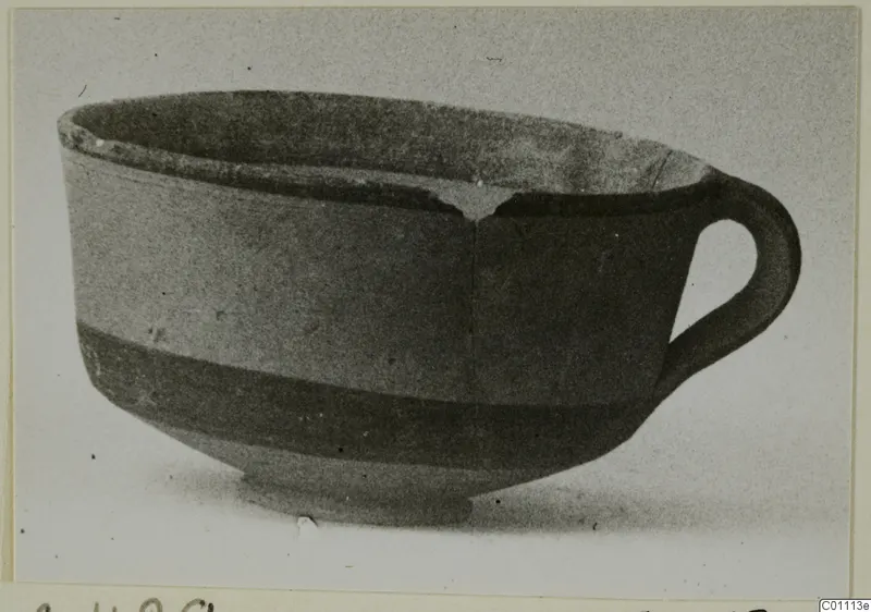Pottery White Painted III-1 bowl with a single loop handle and a dark band around the lower body