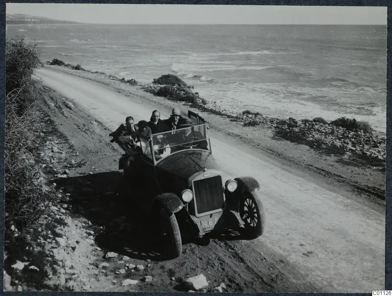 People crowded into an open car on a dirt road along the coast, on the excursion to Limassol