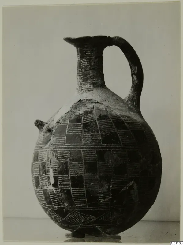 Red Polished II jug from the Vrysi tou Barba tombs at Lapithos, with incised checkerboard pattern and strap handle