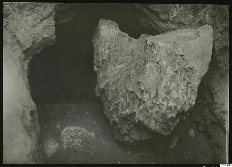 Tomb 5 at Marion during excavation, with large fallen stones in a rock-cut opening