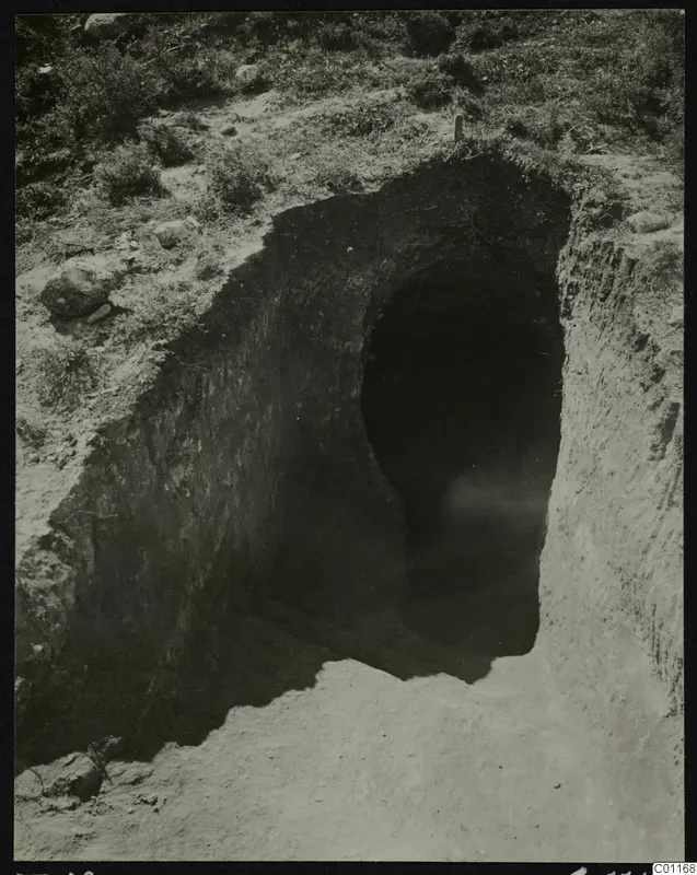 Tomb 12 at Marion during excavation, showing a cut leading down to a dark tomb opening