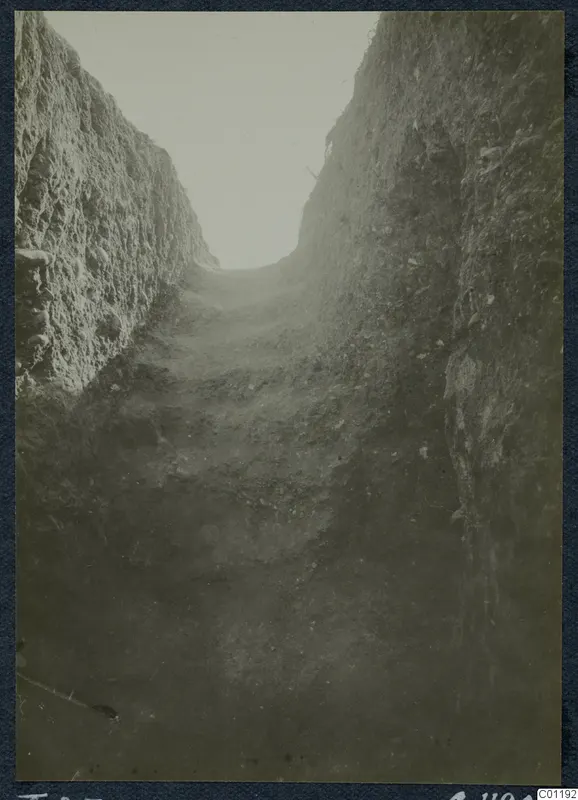 Deep excavation trench at Marion, Tomb 25, with stepped ground and stones along its sides