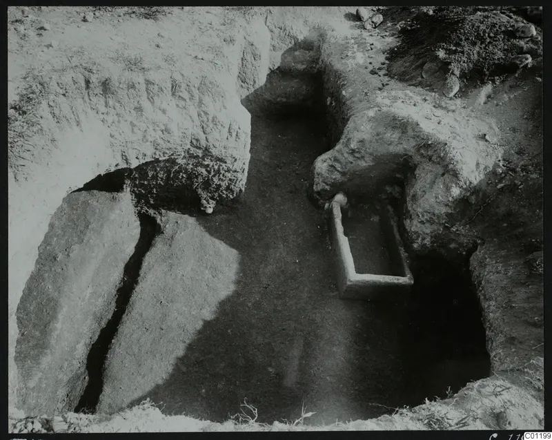 Tomb 15 at Marion, interior seen towards the dromos, with a rectangular pale stone trough and cut stone slabs beside it