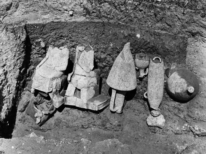 Sculpture fragments and pottery vessels lying in situ in Tomb 30 at Marion