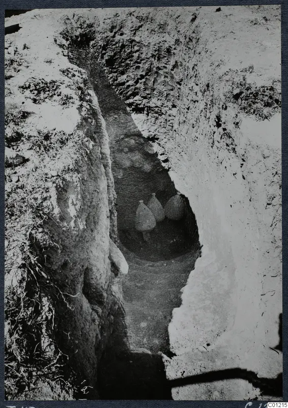 Tomb 43 at Marion: a steep-sided cutting leading down to three vessels at its base