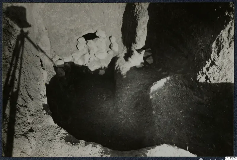 Tomb 40 at Marion during excavation, with a heap of pale stones in the cut
