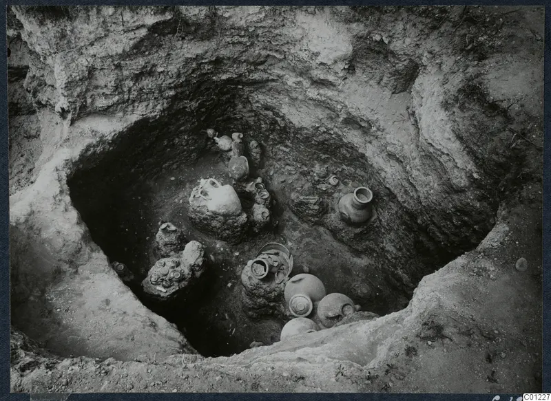 Interior of Tomb 47 at Marion seen from above, with pottery vessels and a possible skull on the tomb floor