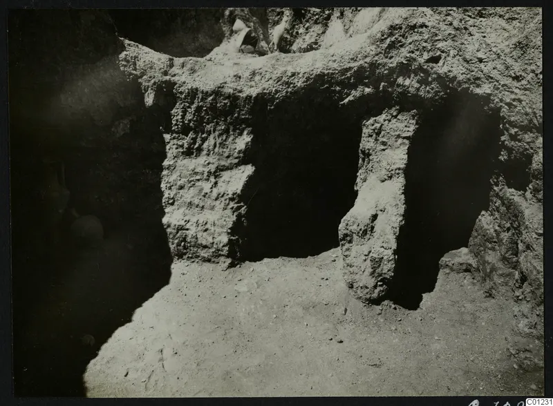 Tomb 16 at Marion during excavation, with a vessel and stones visible in the cut