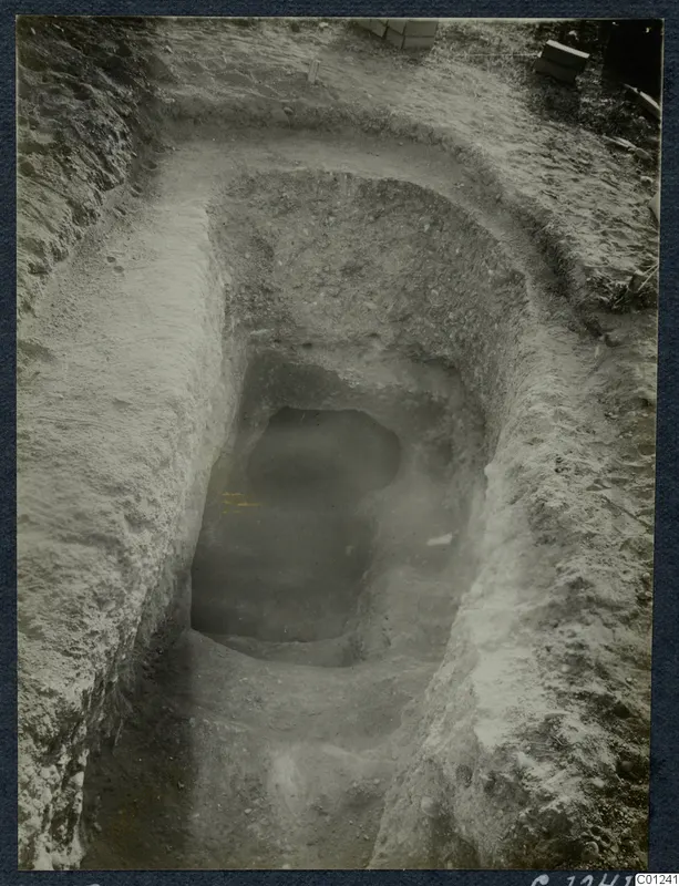 Excavation of Tomb 33 at Marion, with a dromos cut down to the dark opening of a tomb chamber