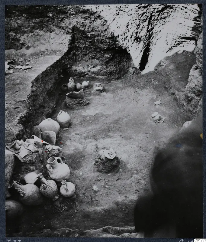 Tomb 37 at Marion during excavation, with pottery vessels lying in situ along the side of the pit