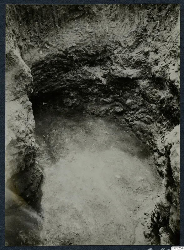 Tomb 31 at Marion during excavation, seen from above with curved cut walls and a pale floor