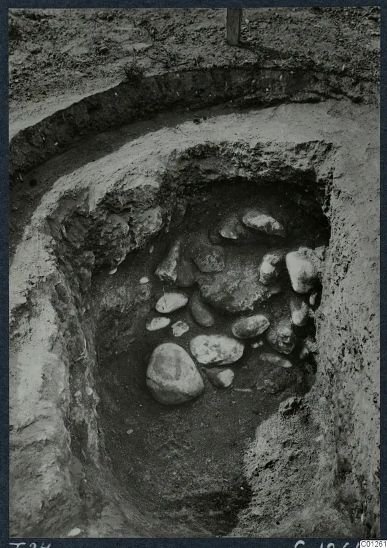 Tomb 24 at Marion: excavated pit with a cluster of stones in the fill